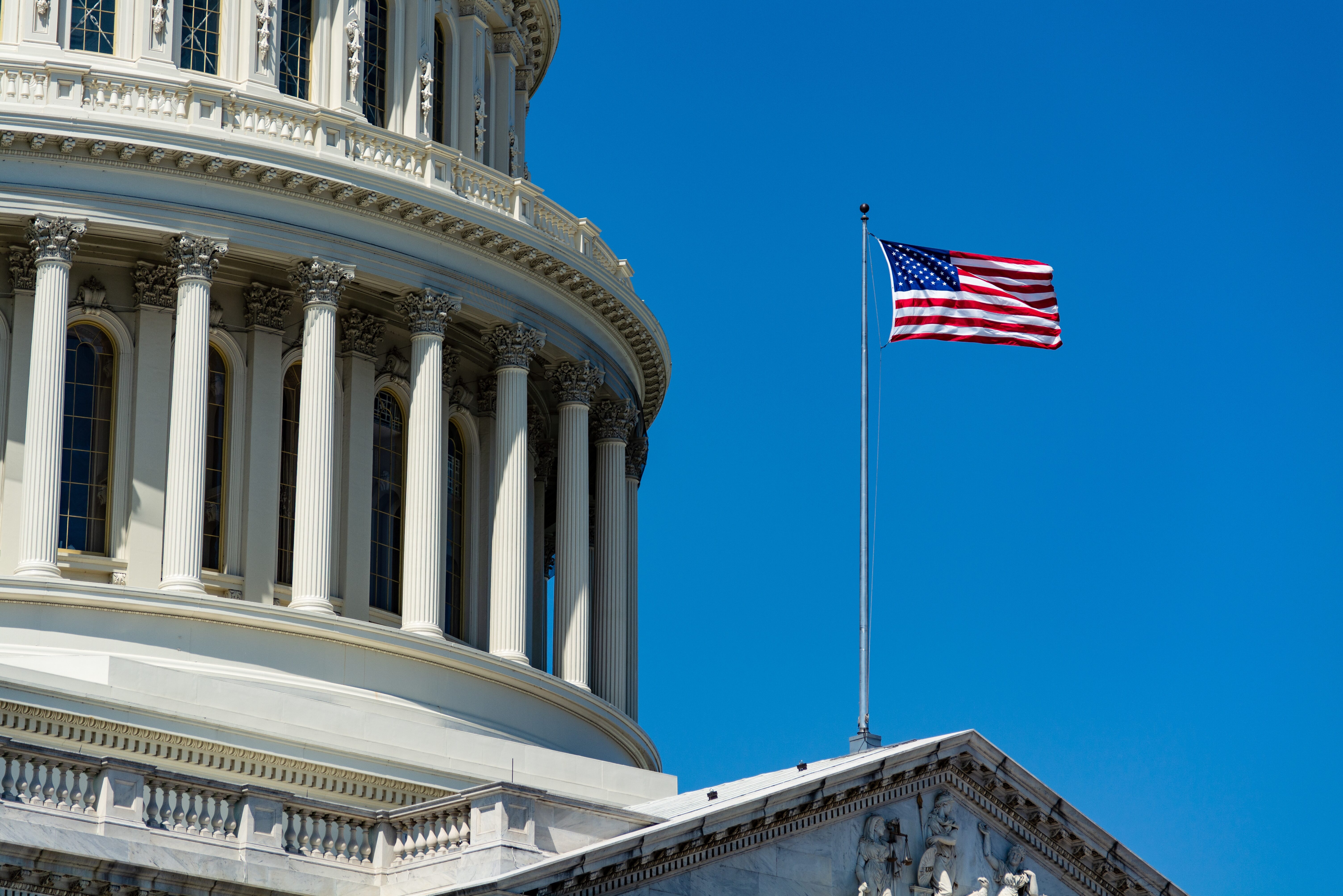 A close up on the flag outside of the U.S. Capitol building.