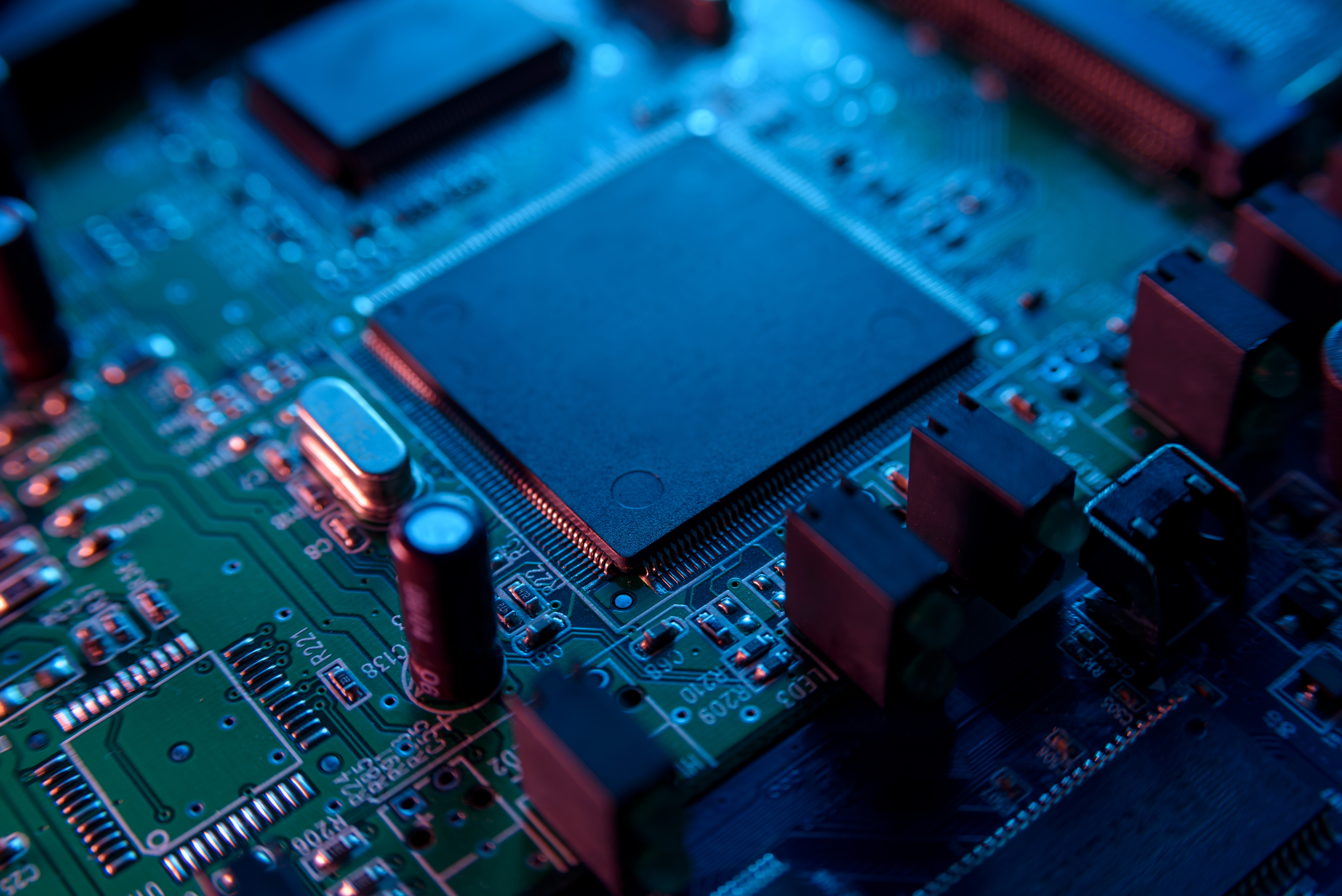 A picture microcircuit with chip close up with neon lighting.