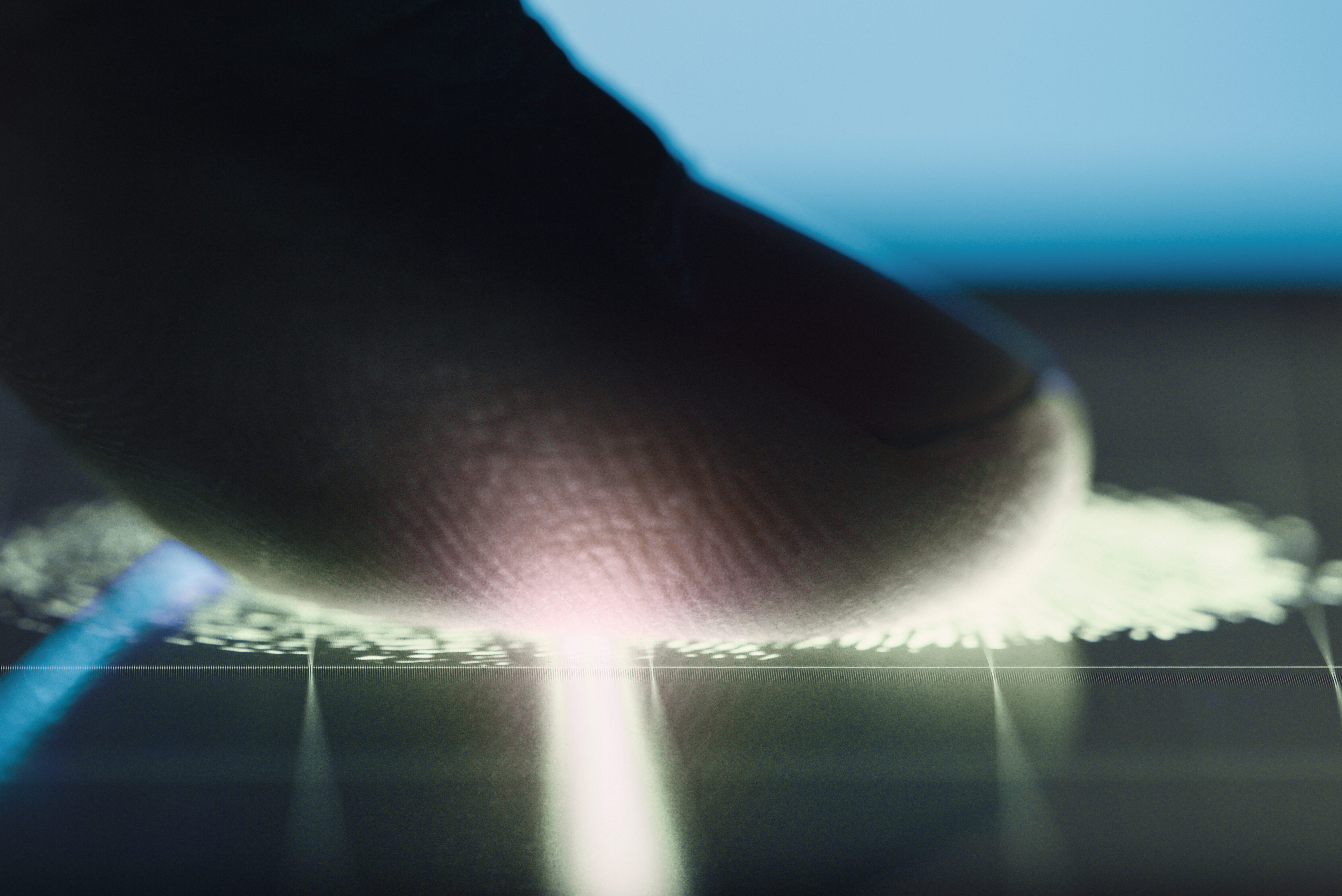 A finger on a biometric scanner.